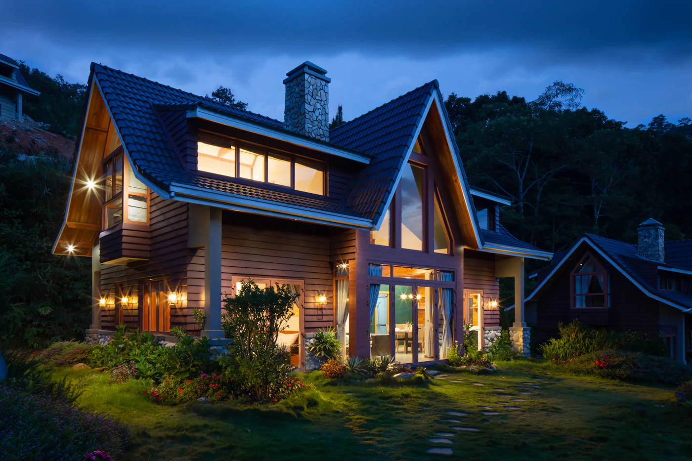 Modern timber-clad home glowing at dusk
